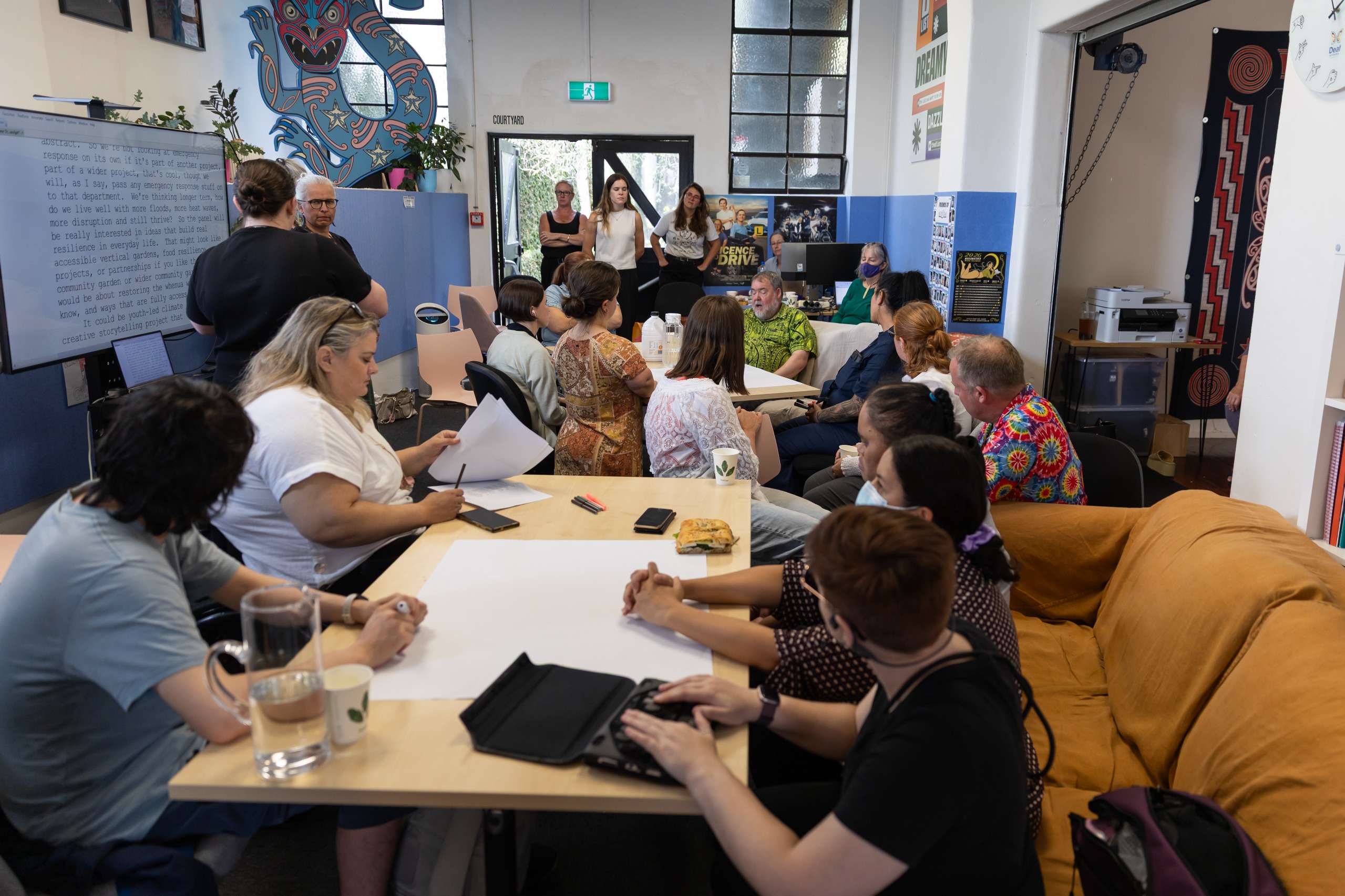 Photo of focus group at D*List, attendees at tables having discussions