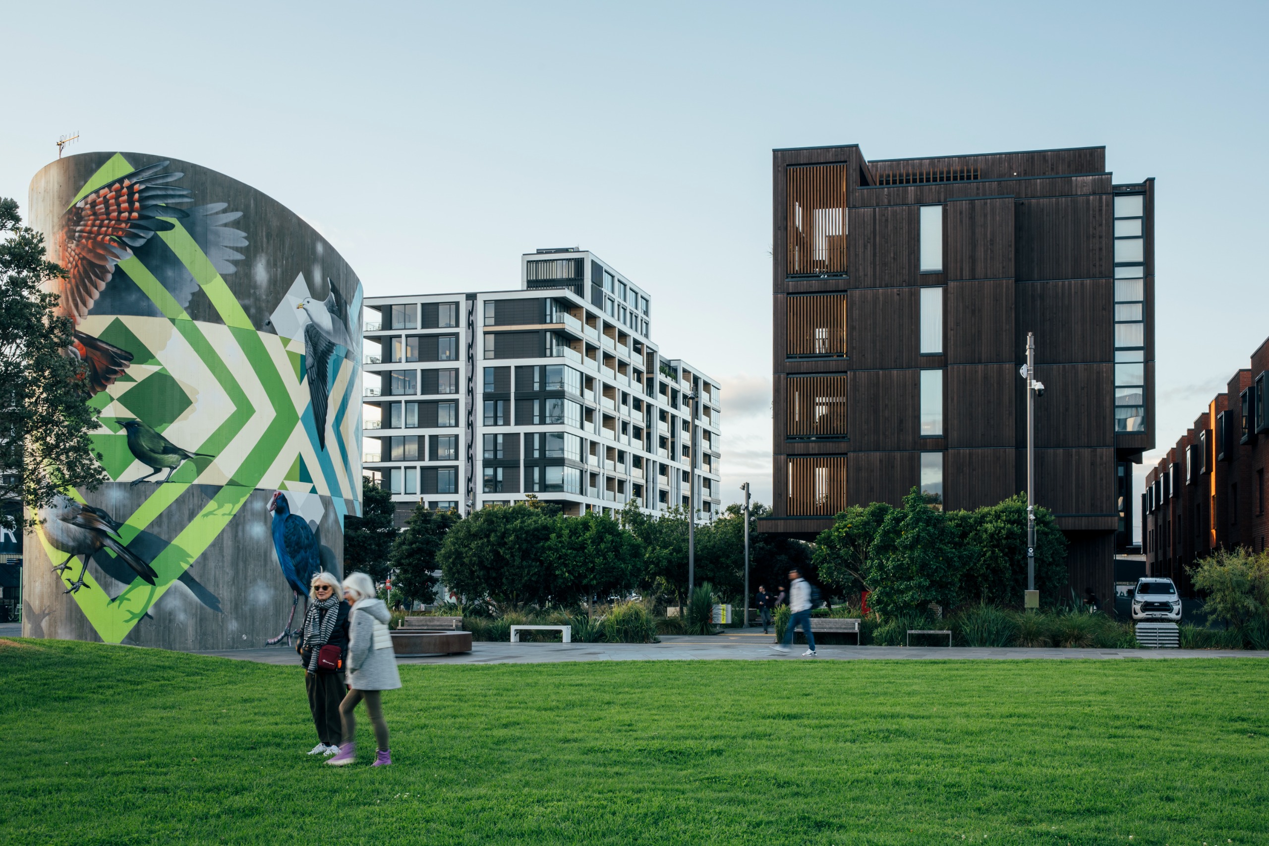 Urban development at Wynyard quarter. Two apartment block side by side are shown with a large green field in the foreground.