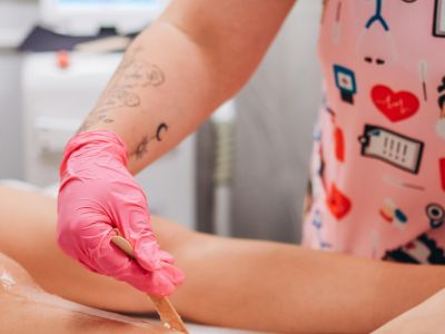 Person getting their legs waxed in a spa
